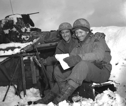 491st AFA men read letters from home, February 11. 1945.